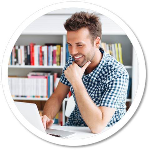 Male student studying in front of a laptop.